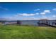 Lush green lawn leading to the lakefront, enhanced by private docks with covered seating areas at 153 Summershore Dr, Auburndale, FL 33823