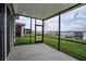 Screened-in lanai with a view of the backyard and lake with dock at 153 Summershore Dr, Auburndale, FL 33823