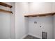 Walk-in closet with wood shelving and hookups for washer and dryer at 153 Summershore Dr, Auburndale, FL 33823