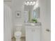 Bright bathroom with granite countertop vanity, framed mirror, and a shower with a white curtain at 1703 Linz Ct, Winter Haven, FL 33884