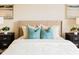 Inviting bedroom featuring cozy bedding, turquoise pillows, and matching black nightstands at 1703 Linz Ct, Winter Haven, FL 33884