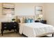 Bedroom with cozy bedding, decorative pillows, matching lamps, and stylish nightstands at 1703 Linz Ct, Winter Haven, FL 33884