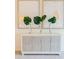 Elegant cabinet with tropical leaf decor adds a touch of sophistication to the living space at 1703 Linz Ct, Winter Haven, FL 33884