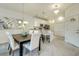 Inviting dining area with a modern table and chairs, flowing into a kitchen with stainless steel appliances at 1703 Linz Ct, Winter Haven, FL 33884