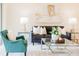 Inviting living room features a sofa, accent chairs, glass coffee table, and stylish decor at 1703 Linz Ct, Winter Haven, FL 33884