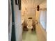 Small, simple bathroom with linoleum flooring, toilet, vanity, and basic fixtures at 201 Cleveland Avenue, Winter Haven, FL 33881