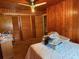 Simple bedroom features wood paneling, overhead lighting, and carpeted floors at 201 Cleveland Avenue, Winter Haven, FL 33881