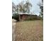 Modest single-story home with brick facade and mature trees in an established neighborhood at 201 Cleveland Avenue, Winter Haven, FL 33881