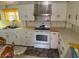 Traditional kitchen with white cabinetry, standard appliances, and laminate countertops at 201 Cleveland Avenue, Winter Haven, FL 33881