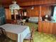 Open-concept living room, with a view of a kitchen area and featuring wood-paneled walls at 201 Cleveland Avenue, Winter Haven, FL 33881