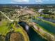 Aerial view of a home and extensive lake system with recreation; red pin marks the home location at 20143 Sunset Landing Ave, Groveland, FL 34736