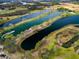 An aerial view of a lake system, complete with a boat and recreational area at 20143 Sunset Landing Ave, Groveland, FL 34736