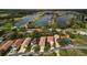 Aerial view of homes lining a lake, with boats visible in the distance on the water at 20143 Sunset Landing Ave, Groveland, FL 34736