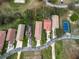 Birds-eye view of a home with a terracotta roof and mature landscaping near a tennis court at 20143 Sunset Landing Ave, Groveland, FL 34736