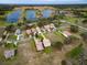 Scenic aerial view of a residential community featuring waterfront homes and lake access for recreational boating at 20143 Sunset Landing Ave, Groveland, FL 34736
