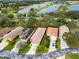 A vibrant aerial view showcasing homes nestled amidst lush landscaping and serene lakes at 20143 Sunset Landing Ave, Groveland, FL 34736