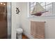 Cozy bathroom has a walk-in shower, decorative nautical accents, and bright window at 20143 Sunset Landing Ave, Groveland, FL 34736