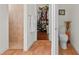 Bathroom featuring a walk-in shower, toilet and entrance to walk-in closet at 20143 Sunset Landing Ave, Groveland, FL 34736