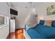 Bedroom with bright, sunny windows and a blue bedspread at 20143 Sunset Landing Ave, Groveland, FL 34736