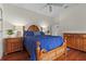 Nicely appointed bedroom featuring a wood bed frame, hardwood floors, and matching furniture at 20143 Sunset Landing Ave, Groveland, FL 34736
