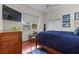 Comfortable bedroom with a window view, a ceiling fan, and a flat screen television at 20143 Sunset Landing Ave, Groveland, FL 34736