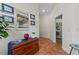 Hallway features terra cotta flooring, white walls, and access to the laundry room at 20143 Sunset Landing Ave, Groveland, FL 34736