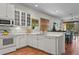 Open concept kitchen with white appliances and a spacious countertop, ideal for entertaining at 20143 Sunset Landing Ave, Groveland, FL 34736