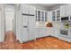 Kitchen with white cabinets, stainless steel appliances, and terracotta floors at 20143 Sunset Landing Ave, Groveland, FL 34736