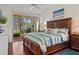 Primary bedroom with a king bed, ensuite bathroom, and access to the back patio at 20143 Sunset Landing Ave, Groveland, FL 34736