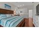 Primary bedroom with a king bed, ensuite bathroom, and hardwood floors at 20143 Sunset Landing Ave, Groveland, FL 34736