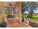 Charming screened-in patio with outdoor furniture, offering a relaxing view of the surrounding greenery at 20143 Sunset Landing Ave, Groveland, FL 34736