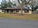 Charming one-story brick home featuring a well-maintained yard and mature trees at 2016 Amesbury Dr, Auburndale, FL 33823