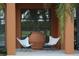 Inviting front porch with seating and a decorative terra cotta pot, reflecting the surrounding lush greenery at 2300 N Scenic Hwy # 120, Lake Wales, FL 33898