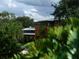 Modern home partially obscured by lush, tropical vegetation at 2300 N Scenic Hwy # 120, Lake Wales, FL 33898