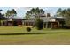 Expansive lawn and modern single story home with a metal roof at 2300 N Scenic Hwy # 120, Lake Wales, FL 33898