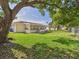 Spacious backyard with a screened-in porch and mature trees at 2434 Mill Run Blvd, Kissimmee, FL 34744