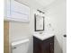 Bathroom featuring a dark vanity and a mirror over the sink at 2434 Mill Run Blvd, Kissimmee, FL 34744
