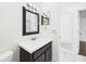 Bathroom featuring a dark vanity and a mirror over the sink at 2434 Mill Run Blvd, Kissimmee, FL 34744
