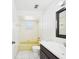 Full bathroom with yellow tiled tub and white tiled floors at 2434 Mill Run Blvd, Kissimmee, FL 34744