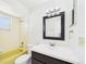 Full bathroom with classic yellow bathtub and updated vanity at 2434 Mill Run Blvd, Kissimmee, FL 34744