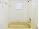 Full bathroom with classic yellow bathtub and shower combination at 2434 Mill Run Blvd, Kissimmee, FL 34744