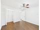 Bedroom with wood-look flooring, closet, and ceiling fan at 2434 Mill Run Blvd, Kissimmee, FL 34744