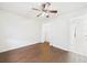 Bedroom with wood-look flooring, closet, and view to tiled hall at 2434 Mill Run Blvd, Kissimmee, FL 34744
