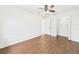 Bedroom with wood-look floors, a ceiling fan, and closet with shelving system at 2434 Mill Run Blvd, Kissimmee, FL 34744