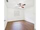 Bright bedroom featuring wood-look flooring, ceiling fan, and a window at 2434 Mill Run Blvd, Kissimmee, FL 34744