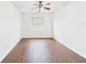Bright bedroom featuring wood-look floors and a ceiling fan for added comfort at 2434 Mill Run Blvd, Kissimmee, FL 34744