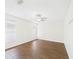 Bright bedroom with wood-look floors, ceiling fan, and natural light from windows at 2434 Mill Run Blvd, Kissimmee, FL 34744