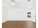 Bedroom featuring wood-look floors and access to kitchen at 2434 Mill Run Blvd, Kissimmee, FL 34744