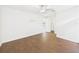 Bright bedroom featuring wood-look floors, access to bathroom and closet at 2434 Mill Run Blvd, Kissimmee, FL 34744