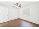 Bedroom with wood-look floors, ceiling fan, and natural light at 2434 Mill Run Blvd, Kissimmee, FL 34744